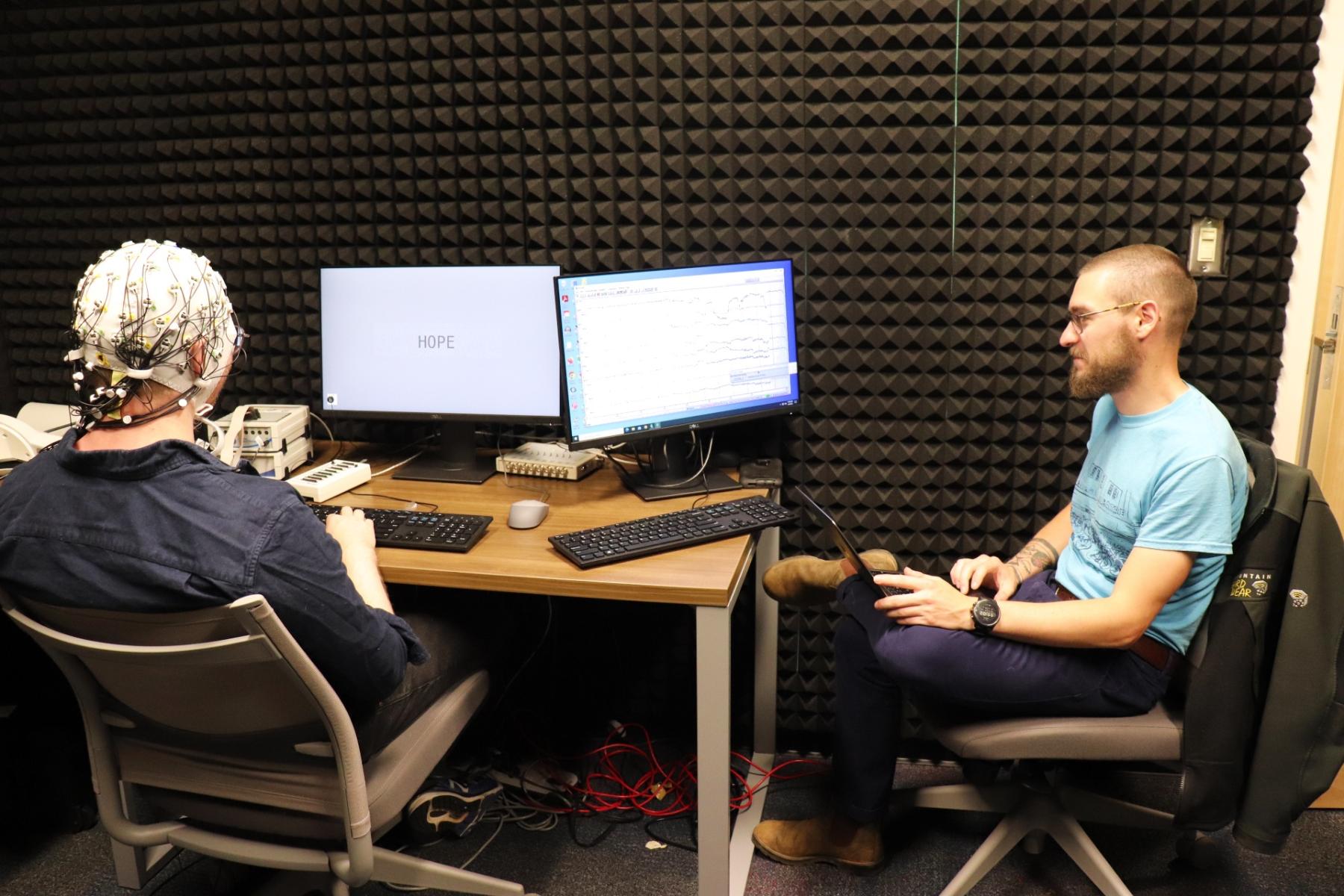 Dr. Dustin Chacón and Donnie Dunagan conduct research using the Linguistic Lab EEG Machine.