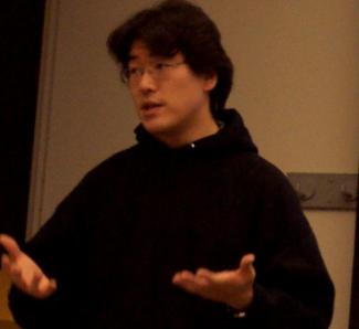 Picture of Dr. Masaya Yoshida in black hoodie talking in classroom