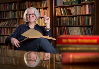 Kim Waters in front of bookcase