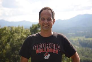 Dr. Michał Głuszkowski smiles in a UGA Bulldog shirt