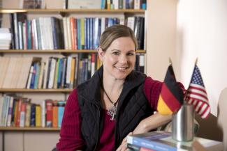 Photograph of Dr. Vera Lee-Schoenfeld in front of bookshelves